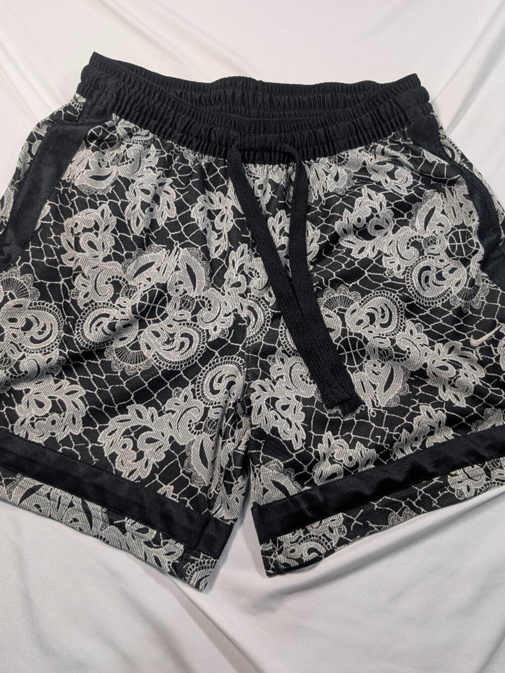 Nike Dri-FIT patterned athletic shorts in black and white.